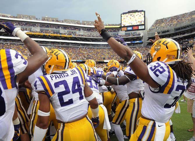 LSU football players huddle and chant before the game Saturday, September 6, 2014 after the Tigers' 56-0 blow out against Sam Houston State in Tiger Stadium.