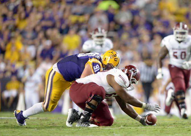 NMSU junior offensive line Isaiah Folasa-Lutui fumbles the ball in game against LSU in Tiger Stadium Saturday, September 27, 2014.