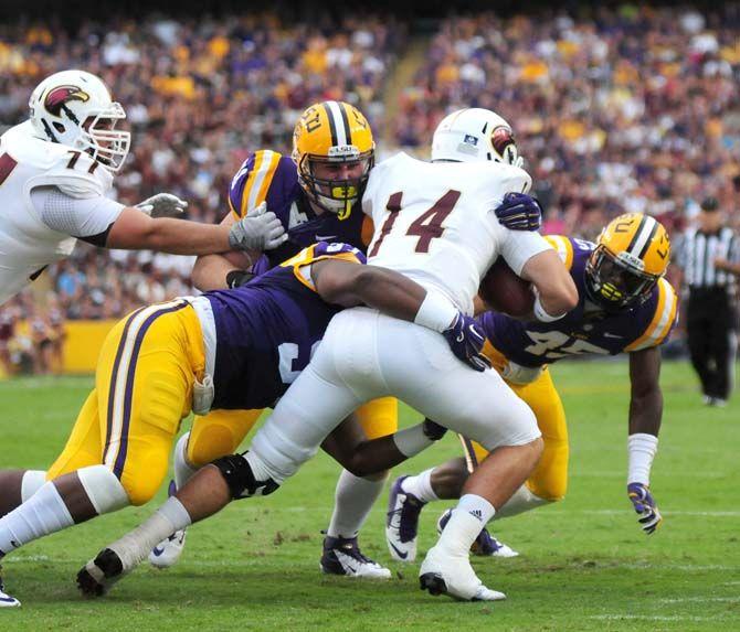 Members of the LSU defense bring down ULM senior quarterback Pete Thomas (14) Saturday, Sep. 13, 2014 during the Tigers' 31-0 victory against the Warhawks in Tiger Stadium.