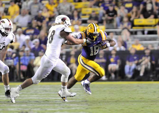 LSU senior running back Terrence Magee (18) attempts to evade a ULM defender Saturday, Sep. 13, 2014 during the Tigers' 31-0 victory against the Warhawks in Tiger Stadium.