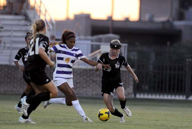 LSU sophomore forward Summer Clarke (4) passes the ball Friday, August 22, 2014 during the Tigers' 2-0 victory against Troy in LSU Soccer Stadium.