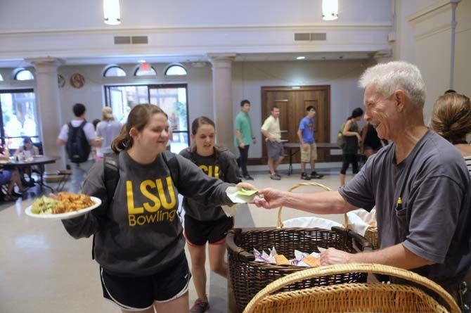 Students enjoy their free lunch probided by Our Lady of Mercy Catholic Church Thursday, September 4, 2014 in Christ the King Catholic Church.