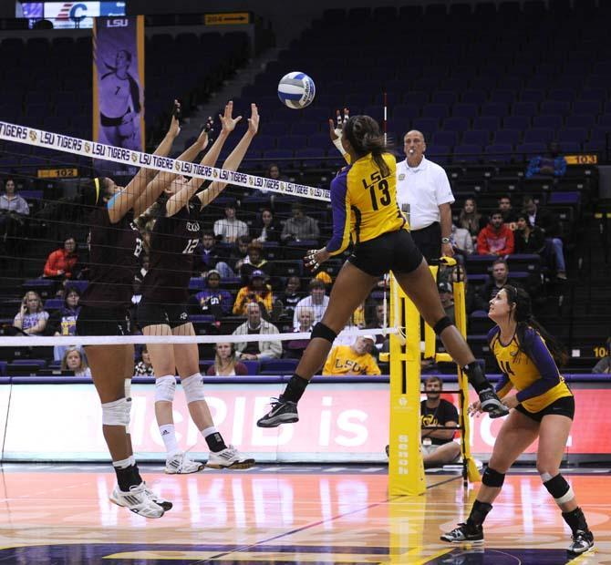 LSU freshman middle blocker Briana Holman (13) goes for a kill Wednesday, Nov. 13, 2013 during the Tigers' match against the Aggies.