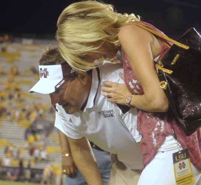 Mississippi State Football head coach Dan Mullen stares at the ground in disbelief while spouse Megan Mulen rejoices after he lead his team to a 34-29 victory in Tiger Stadium Saturday, September 20, 2014.