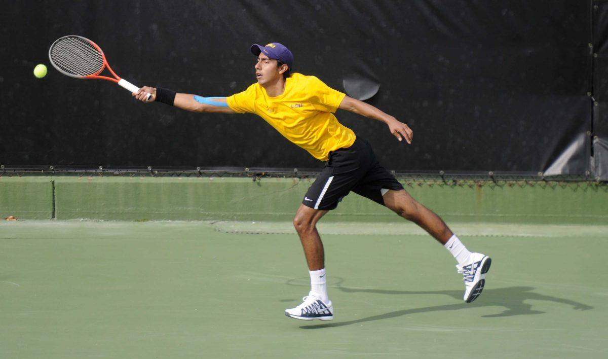 LSU sophomore Boris Arias dstretches to hit the ball Friday, March 7, 2014 during a tennis match against Alabama in W.T. "Dub" Robinson Stadium.