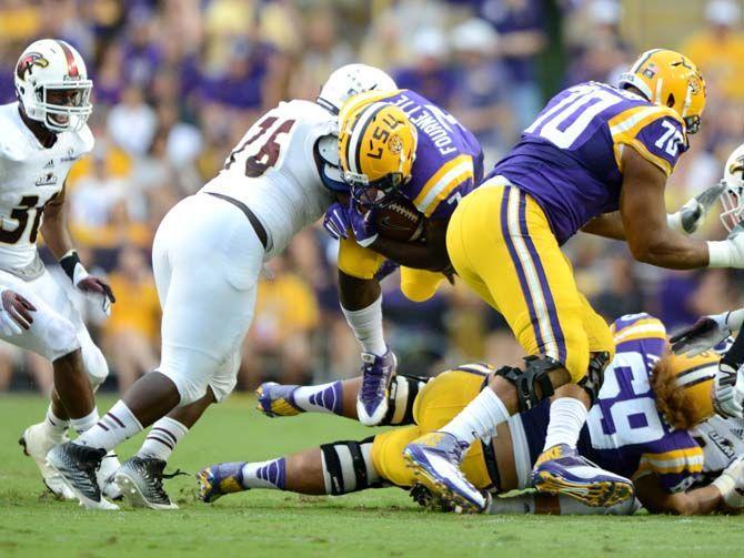 LSU freshman running back Leonard Fournette (7) leaps over his own teammate Saturday, Sep. 13, 2014 during the Tigers' 31-0 victory against the Warhawks in Tiger Stadium.