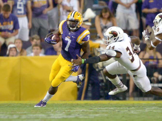 LSU freshman running back Leonard Fournette (7) attempts to evade a ULM defender Saturday, Sep. 13, 2014 during the Tigers' 31-0 victory against the Warhawks in Tiger Stadium.