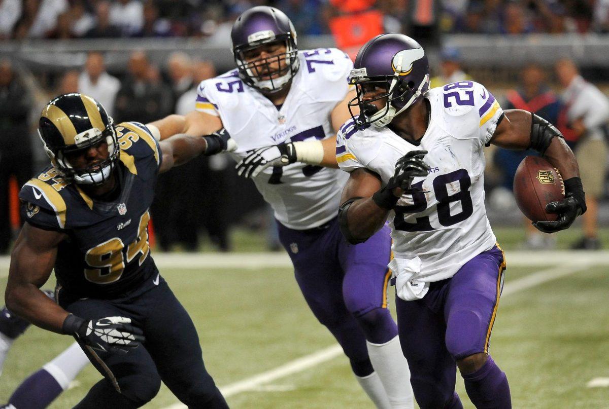 Minnesota Vikings running back Adrian Peterson, right, gets a block from offensive tackle Matt Kalil as St. Louis Rams defensive end Robert Quinn, left, gives chase during the third quarter an NFL football game Sunday, Sept. 7, 2014, in St. Louis. (AP Photo/L.G. Patterson)