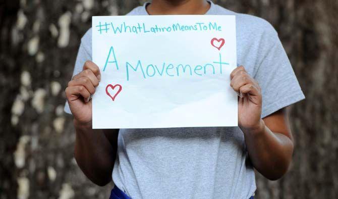 The Hispanic Student Cultural Society make signs about what being Latino means to them.