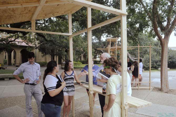 LSU undergraduate architecture proffesor Jeff Carney and architecture proffesor Greg Watson evaluate student built structures Monday, September 8, 2014 in the quad.