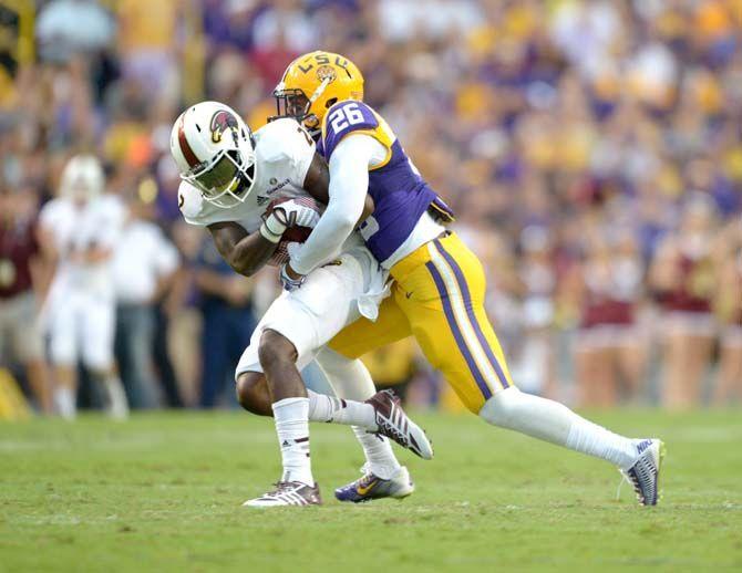 LSU senior safety Ronald Martin (26) brings down a ULM ball carrier Saturday, Sep. 13, 2014 during the Tigers' 31-0 victory against the Warhawks in Tiger Stadium.