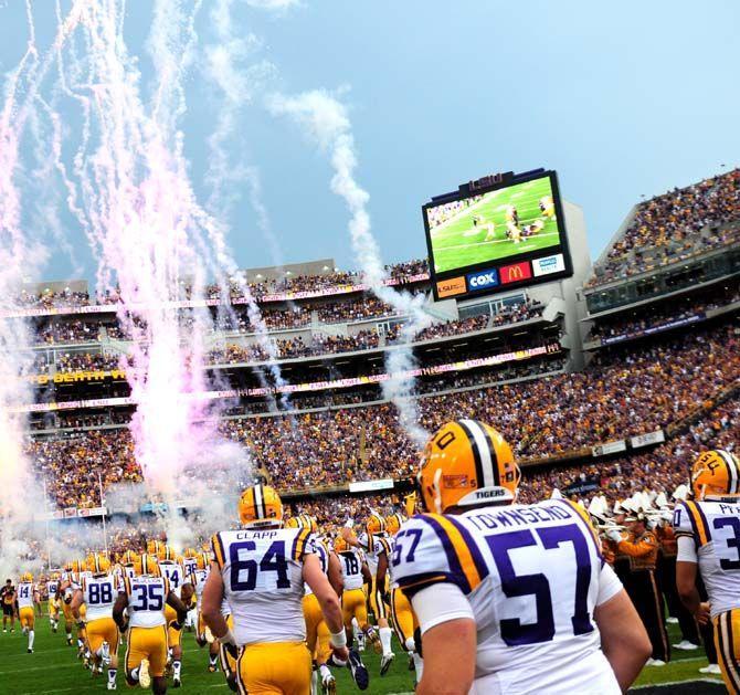 Members of the LSU football team run onto the field Saturday, September 6, 2014 before the Tigers' 56-0 win against Sam Houston State in Tiger Stadium.