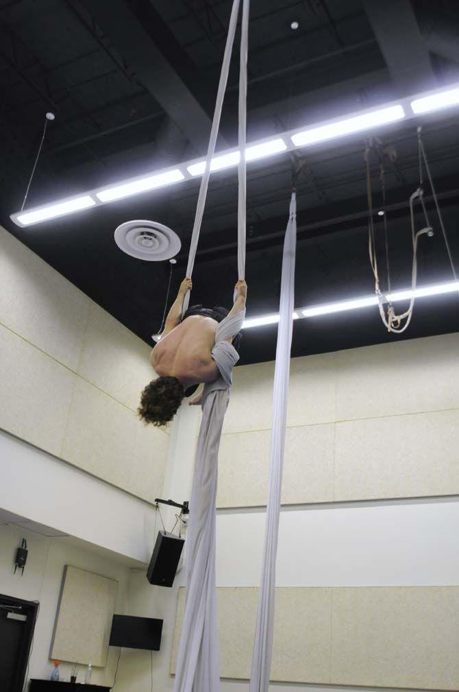 Teaching assistant and co-creator of ORIGIN Mark Gibson hangs from aerial silk.