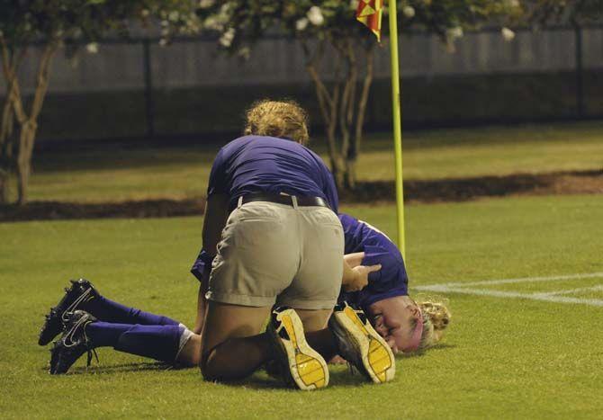 LSU senior midfielder Alex Arlitt (14) falls injured Friday, August 29, 2014 during the Tigers' victory 6-2 against Northwestern St. in LSU Soccer Stadium.