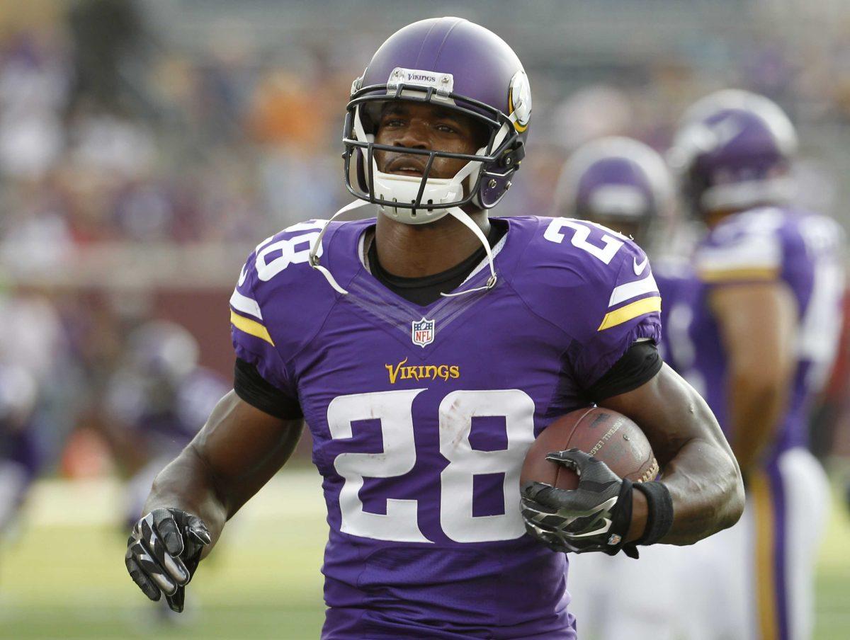 In this Aug. 16, 2014, photo, Minnesota Vikings running back Adrian Peterson (28) warms up before a NFL preseason football game against the Arizona Cardinals in Minneapolis. (AP Photo/Ann Heisenfelt)