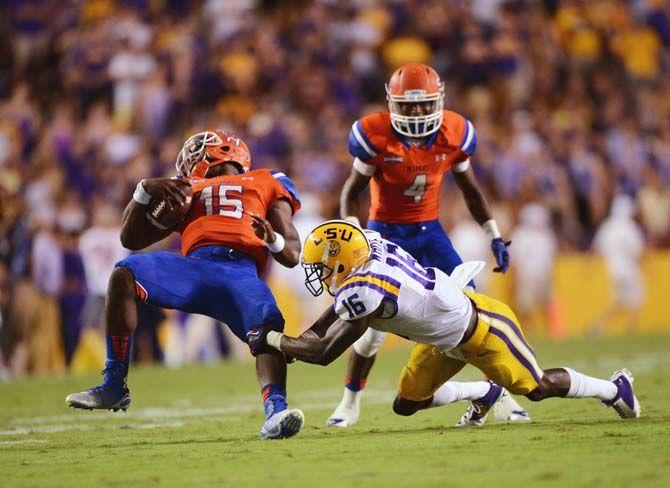 LSU sophomore defensive back Tre'Davious White tackles Sam Houston State sophomore quarterback Jared Johnson Saturday, September 6, 2014 during the Tigers' 56-0 win against the Bearkats in Tiger Stadium.