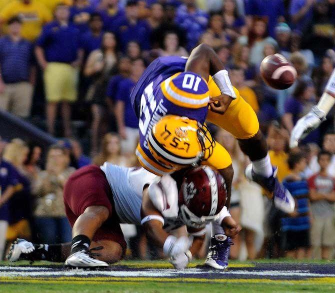 LSU sophomore quarter back Anthony Jennings gets tackled by NMSU player and fumbles the ball Saturday, September 27, 2014 during the Tigers' 63-7 victory against the Aggies in Tiger Stadium.