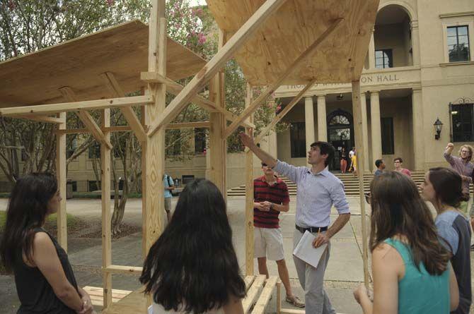 LSU undergraduate architecture proffesor Jeff Carney evaluates student built structures Monday, September 8, 2014 in the quad.