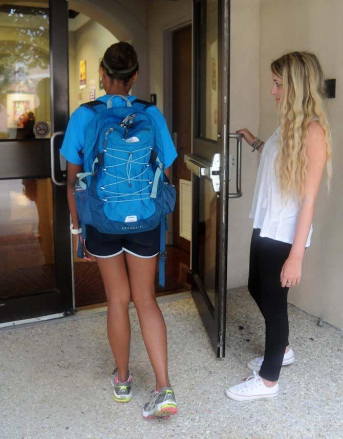 LSU student assists another student by opening the door of East Campus Apartment's Activity Center Tuesday September 2, 2014.