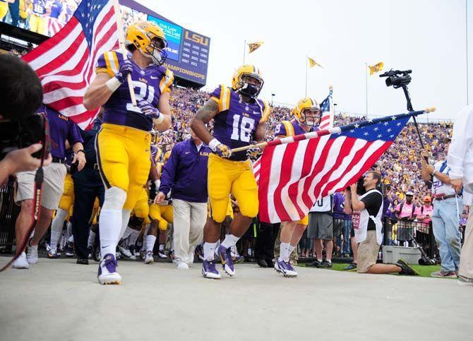 LSU head coach Les Miles leads his team out of the locker room Saturday, Sep. 13, 2014 before the Tigers' 31-0 victory against ULM in Tiger Stadium.