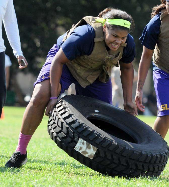 LSU women's basketball junior foward Alexis Hyder flips a tire during practice with the marines on Friday September 19, 2014.