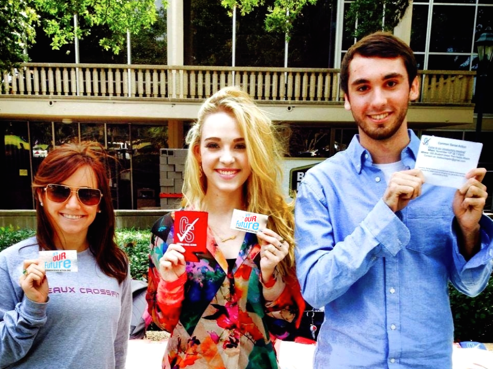 CSA students pose in Free Speech Plaza with voter registration cards.&#160;