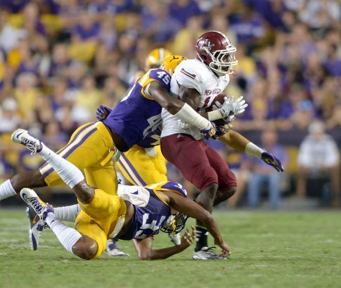 LSU junior linebacker Deion Jones (45) tackles NMSU player in Tiger Stadium on Saturday, September 27, 2014.