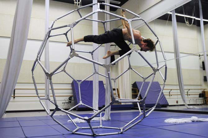 Teaching assistant Mark Gibson poses inside of the aluminum structure built for ORIGIN, a production presented by LSU Theatre.