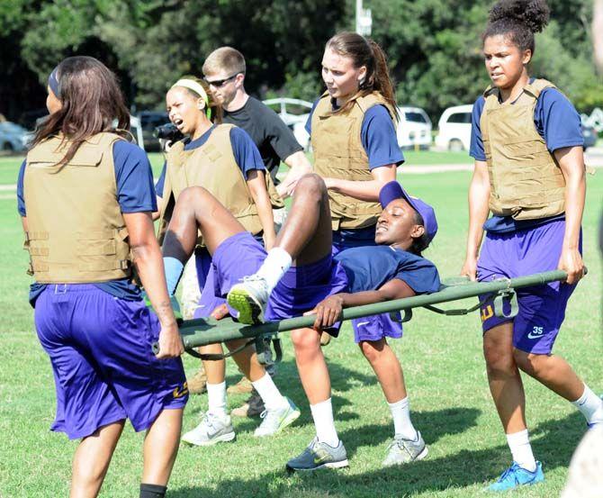 The LSU Women's Basketball team carries sophmore guard Raigyne Moncrief during training with the marines on Friday September 19, 2014.