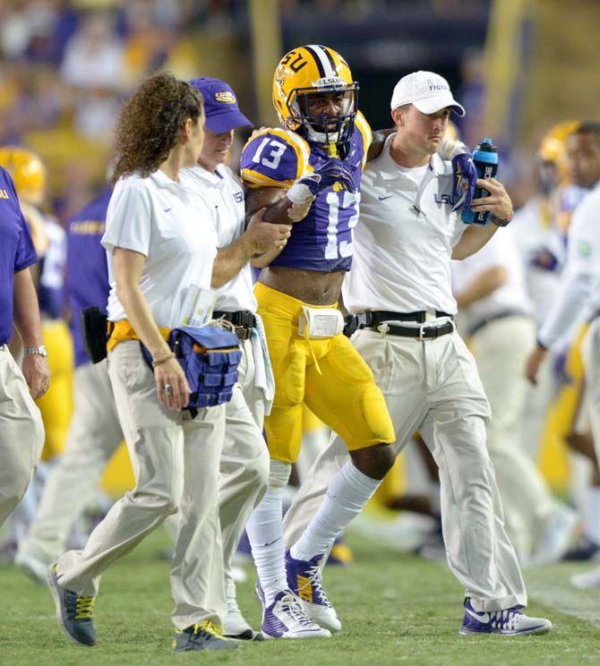 LSU sophomore cornerback Dwayne Thomas is walked off the field after being injured in Tiger Stadium Saturday, September 27, 2014.