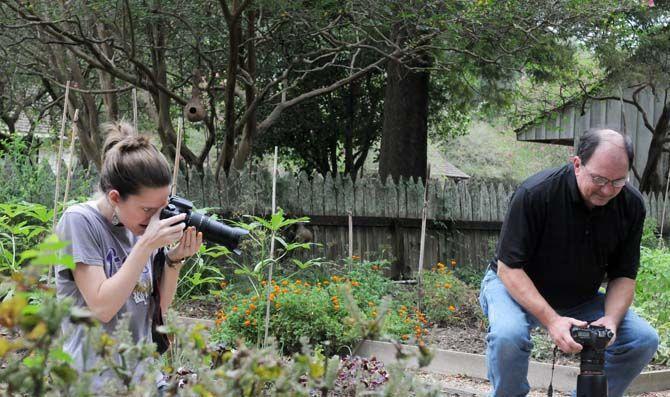 Louisiana Photo Society member Stephanie Ross and President David Arbour photograph on the grounds of the LSU Rural Life Museum during a club field trip.