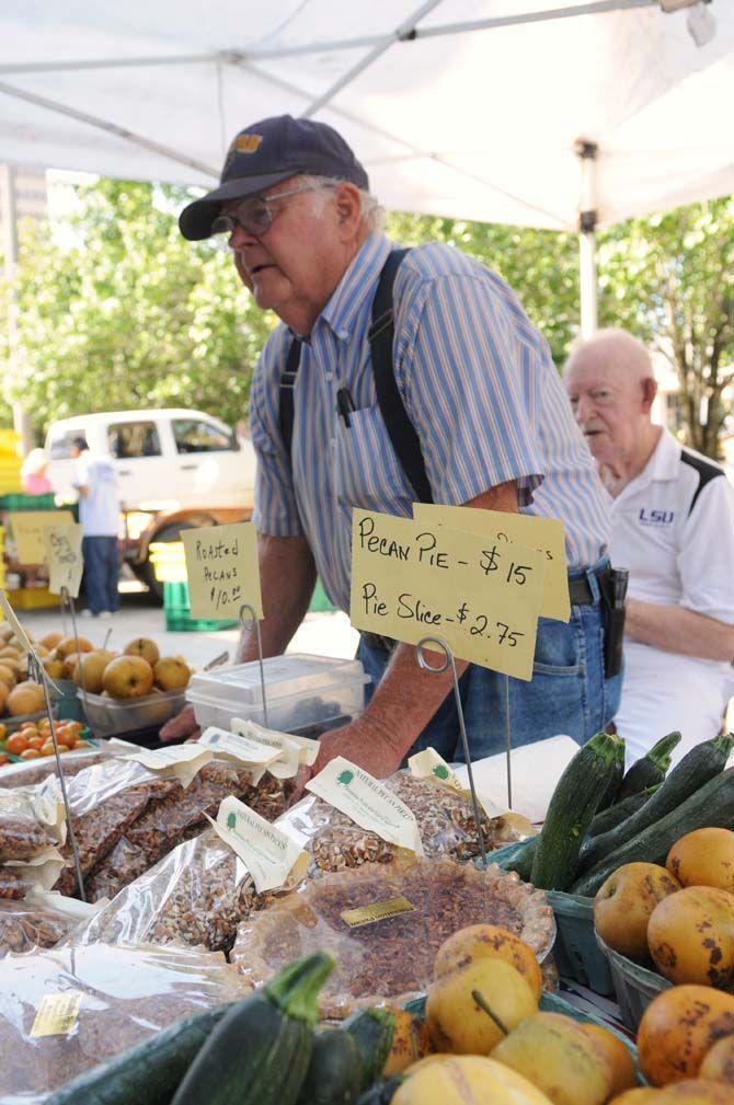 Buddy Miller lets customers taste his fresh Asian pears and cherry tomatos at Red Stick Farmer's Market on Saturday, September 20, 2014. Baton Rouge's Red Stick Farmer's Market is held on Main Street every Saturday.