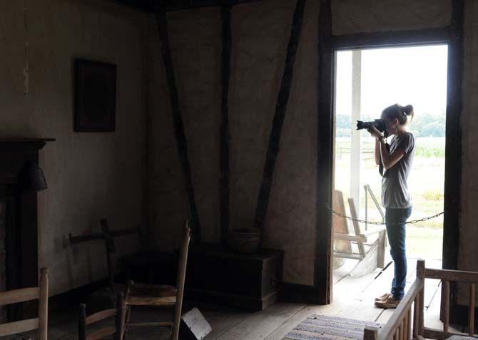 Louisiana Photo Society member Stephanie Ross photographs the inside of an old home at the LSU Rural Life Museum.