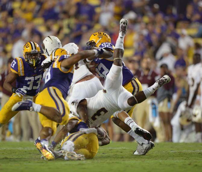 The LSU Tigers' defense smothers the ball carrier during the Tigers' 31-0 victory against ULM on Saturday, September 13th, 2014.