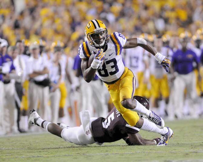 LSU sophmore wide receiver Travin Dural (83) scores a touchdown while avoiding Mississippi State senior defensive back Jamerson Love (5) during the game Saturday September 20, 2014 in Tiger Stadium where the Tigers lost 34-29.