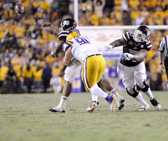 LSU sophmore defensive tackle Christian LaCouture (91) tackles Mississippi State junior quarterback Dak Prescott (15) at the game Saturday September 20, 2014 where LSU lost 34-28 in Tiger Stadium.