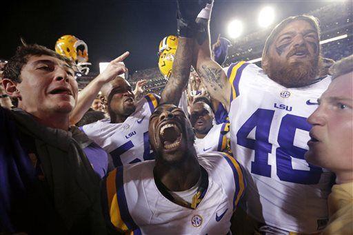 LSU defensive back Tre' Sullivan (44) and tight end Jake Franklin (48) celebrate with fans after LSU's 10-7 victory over Mississippi in an NCAA college football game in Baton Rouge, La., Saturday, Oct. 25, 2014. LSU won 10-7. (AP Photo/Gerald Herbert)