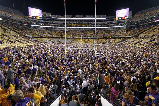 LSU fans swarm the field after their victory over Mississippi in an NCAA college football game in Baton Rouge, La., Saturday, Oct. 25, 2014. LSU won 10-7. (AP Photo/Jonathan Bachman)