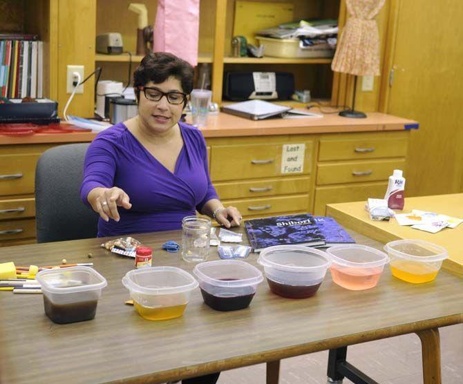 Teacher Lisa McRoberts shows her design students how to use natural dyes as an Eco-friendly alternative Thursday, October 23, 2014.