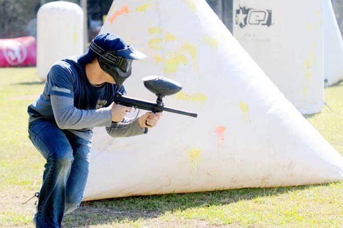 Team member of LSU's Tiger Paintball runs to take cover in a game of speedball.