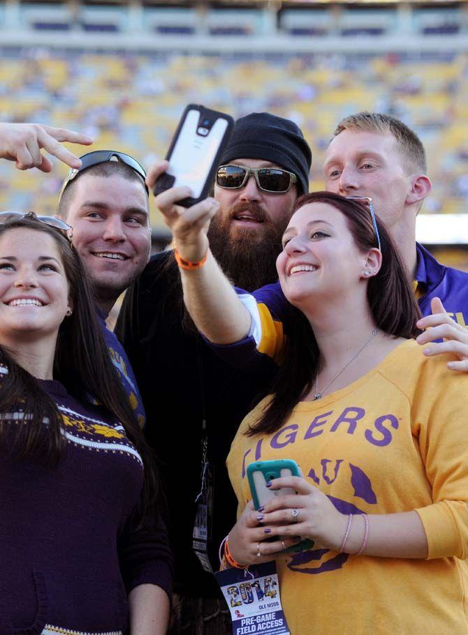 Duck Dynasty's Jase Robertson poses with fans before the LSU game in Tiger Stadium where Tigers won 10-7 against Ole Miss Saturday, October 25, 2014.