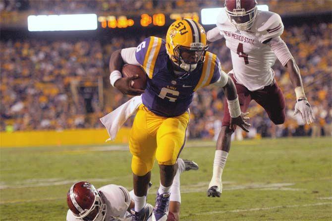 LSU freshman quarterback Brandon Harris (6) runs past NMSU senior defensive back Winston Rose (4) for a first down in the red zone Saturday, September 27, 2014 during the Tigers' 42-7 halftime lead against the Aggies in Tiger Stadium.