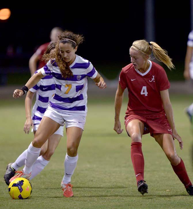 LSU junior junior midfielder Fernanda Pi&#241;a (7) covers the ball against Alabama senior defender Maruschka Waldus (4) during Tigers' 2-3 defeat against Alabama Thursday, October 9, 2014 in the LSU Soccer Stadium.