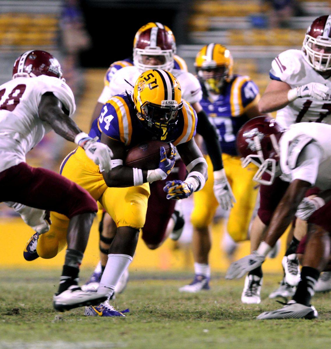 LSU freshman running back Darrel Williams dodges a tackle from multiple NMSU players Saturday, September 27, 2014 during the Tigers' 63-7 victory against the Aggies in Tiger Stadium.