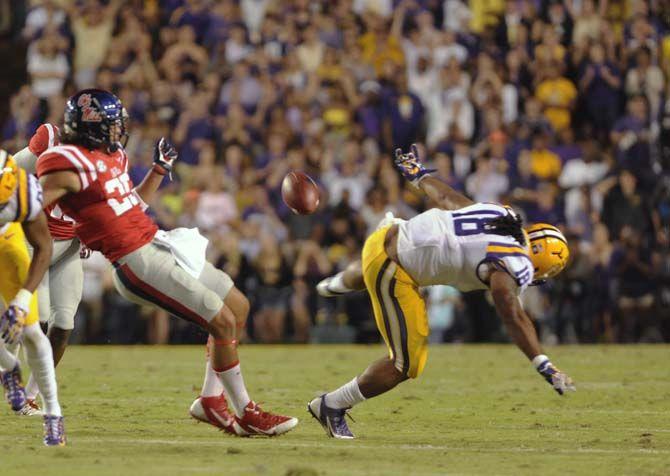 LSU senior running back Terrence Magee fumbles the ball as Ole Miss defender tries to tackle him during Tiger's 10-7 victory Satruday, October 25, 2014 in Tiger Stadium
