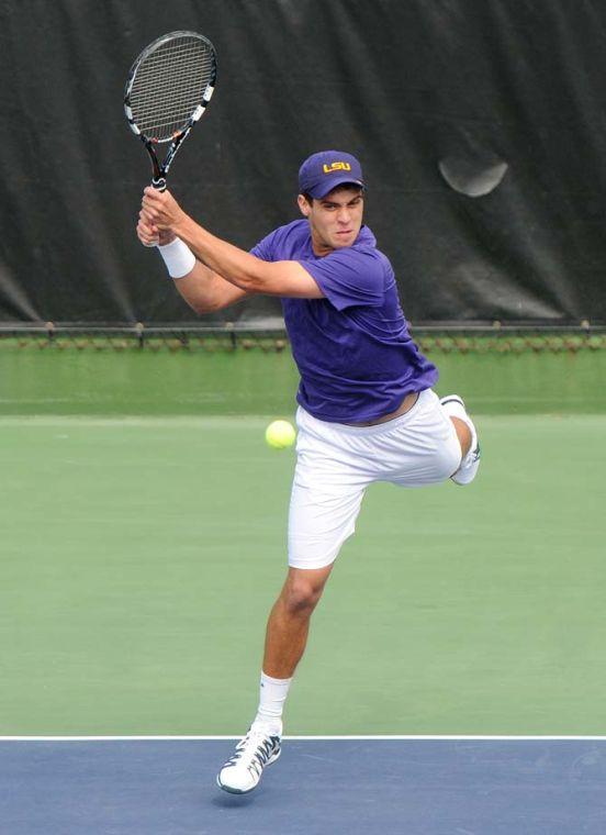 LSU freshman Eric Perez returns a serve Saturday, Feb. 8, 2013 during the Tigers' doubles match at W.T. "Dub" Robinson Stadium.