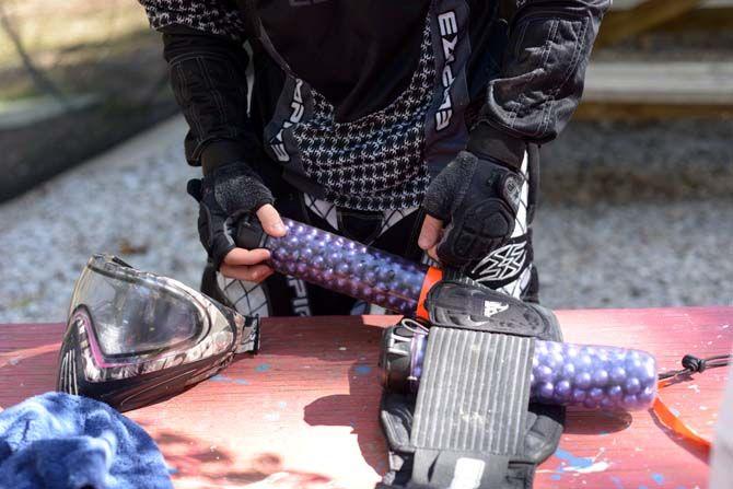 Team member of LSU's Tiger Paintball loads up his gear before a game.