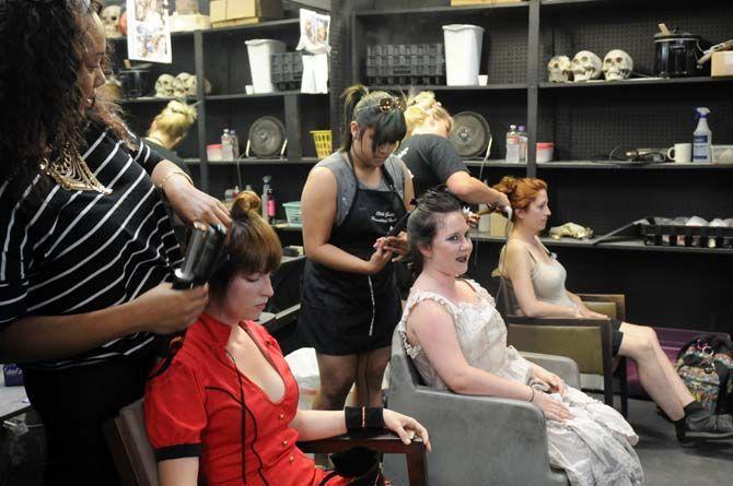 Actors sit backstage to get their hair done for their role in the 13th Gate.