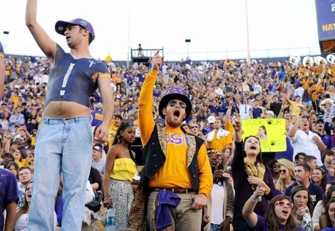 Fans decked out in game wear celebrate an LSU play in Tiger Stadium in a win against Ole Miss 10-7 Saturday, October 25, 2014.