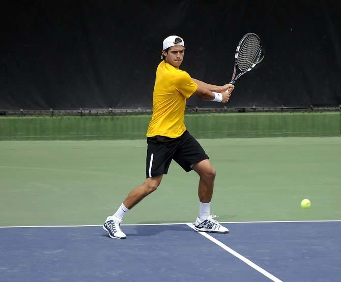 LSU freshman Eric Perez returns a serve Sunday, March 30, 2014 during the Men's Tennis doubles match against Florida at W.T. "Dub" Robinson Stadium.